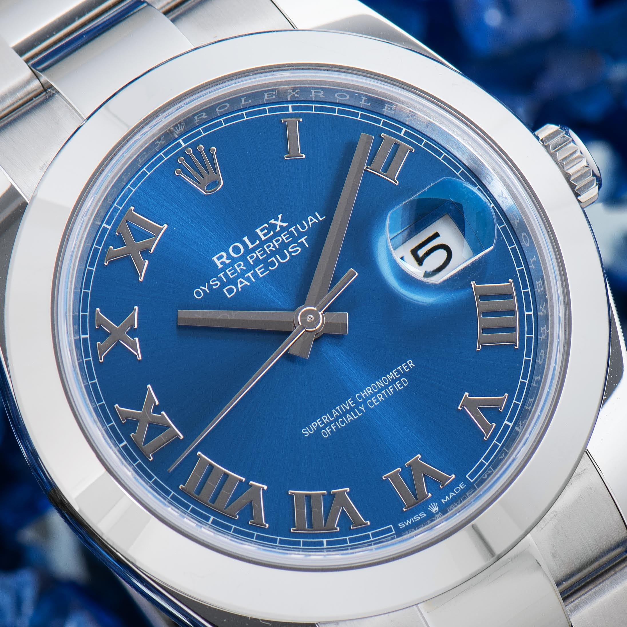 Macro detail of a genuine Rolex Datejust 41 azzurro blue dial with applied Roman numerals and date cyclops