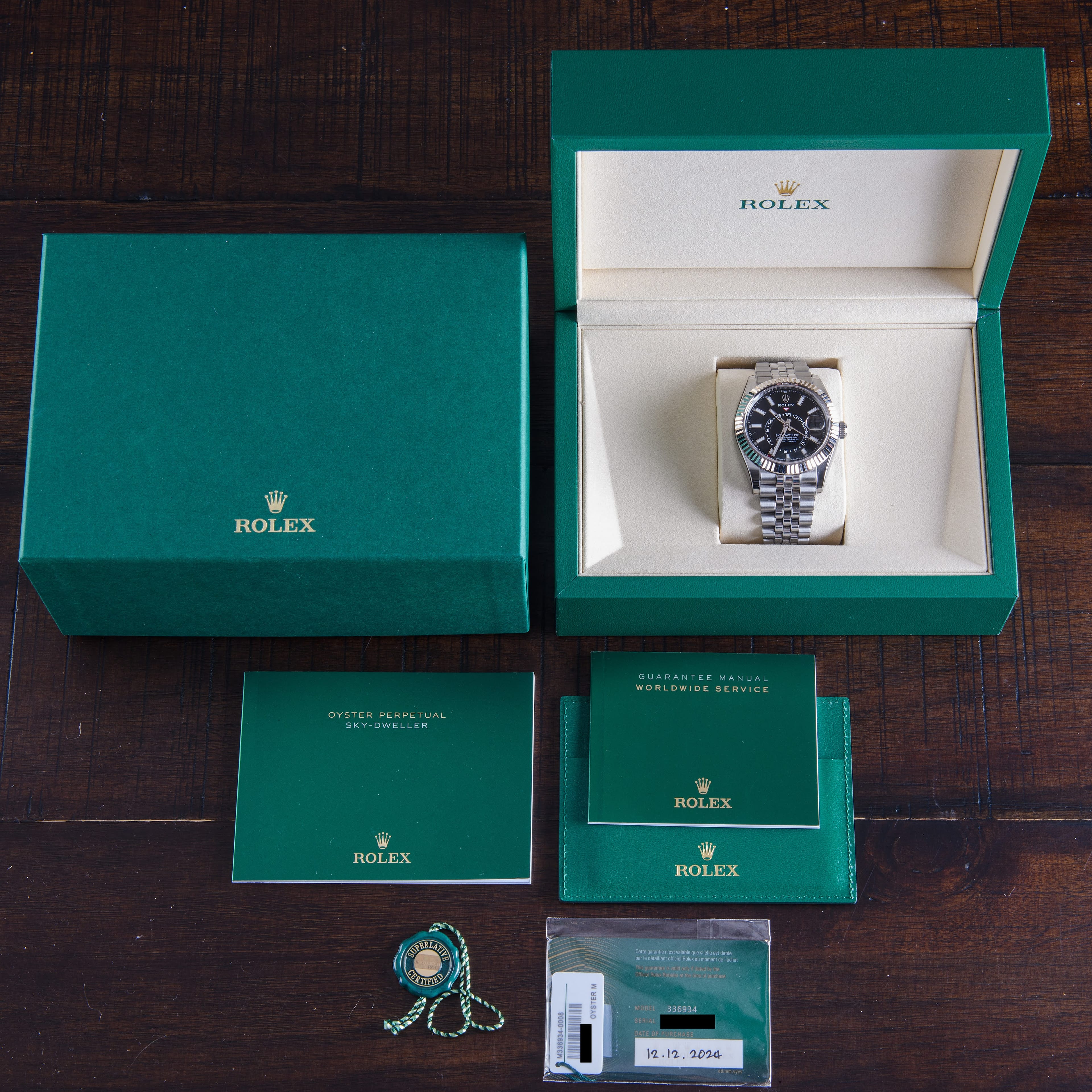 A Rolex Sky-Dweller with its original box and warranty card, the card's serial number matching the watch
